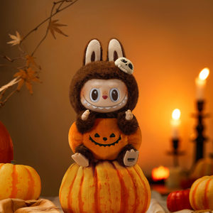 Close up of pumpkin face and vinyl detailing on Halloween plush pendant